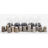 A group of twelve silver thimbles, each of varying design, some in thimble cases, many by Charles Ho