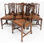 A set of seven George III style mahogany dining chairs, each with fan design to the pierced back, wi
