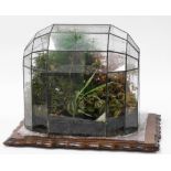 A terrarium, with domed and lead applied top, on a later mahogany fluted base, the dome, 42cm high,