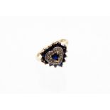 A 9ct gold dress ring, with heart shaped centre with a sapphire surrounded by illusion set tiny cz s