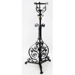 A late 19thC wrought iron and brass oil lamp, with twist column supports, 124cm high.