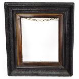 An ebonised picture frame, with brown floral detailed finish, 50cm high, 43cm wide.