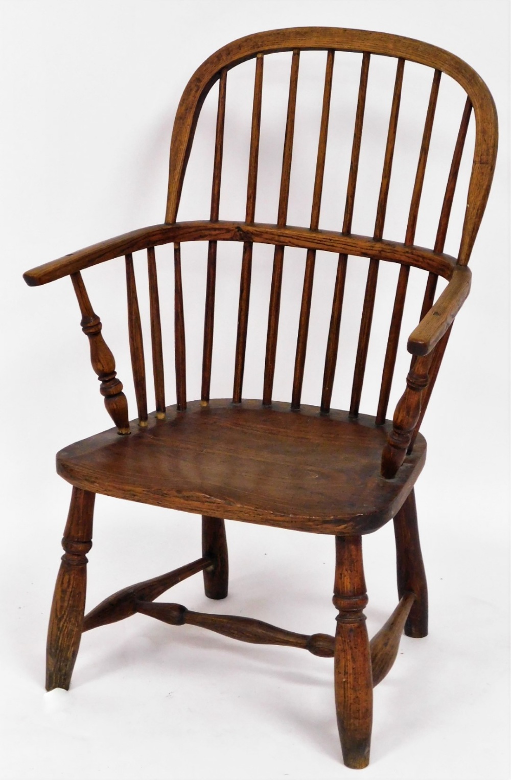 An early 19thC ash and elm Windsor chair, with spindle back and solid seat, 93cm high, 55cm wide, 40