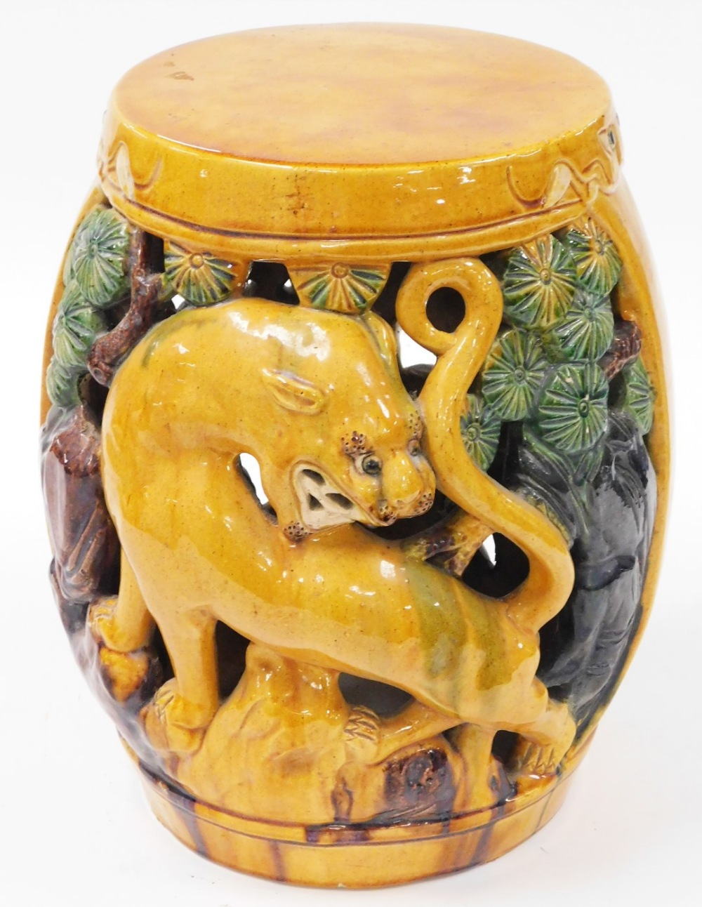 An early 20thC yellow green and brown glazed Chinese barrel seat, decorated with lions and trees, un
