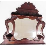 A late 19thC mahogany overmantel mirror, with carved fleur de lis top above central large mirror pla