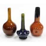 Three Studio Pottery stem vases, the orange fluted example marked Belgium 22cm high, another on a bl