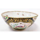 A Booths punch bowl, heavily decorated on a royal blue ground with gilt decoration and figures of ph
