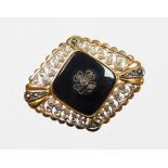 An Art Deco style marcasite and black agate set brooch, formed as a diamond with scroll detailing wi