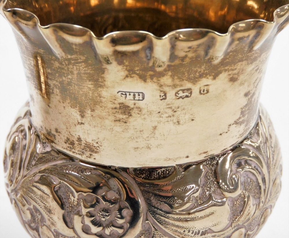 A pair of Edwardian silver thistle shaped vases, with floral crimped borders and embossed flower hea - Image 2 of 3