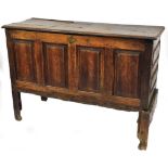 A 17thC and later oak mule chest, the two panelled top above brass escutcheon with four panelled sec