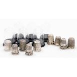 A group of nine silver thimbles, each of varying design, some in thimble cases, many by Charles Horn