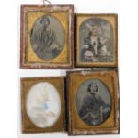 A group of daguerreotype photographs, each depicting figures of ladies in gilt frames. (AF)