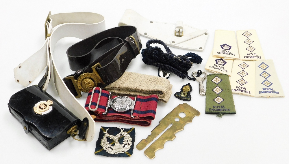 A group of Royal Engineers badges, belts and arm straps, to include a Royal Engineers carry case, be