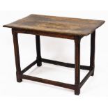 A 17thC oak table, on square chamfered legs and block base with two panelled top, 60cm high, 87cm wi