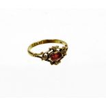 A 9ct gold dress ring, with central design of an oval ruby, in a rub over setting, with pierced and
