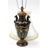 A Victorian majolica style table lamp, converted to electricity, the brown mottled body with floral