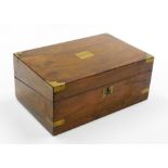 A Victorian walnut writing box, with brass detailing, opening to reveal a black leather inset writin