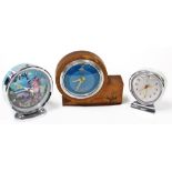 Three mantel clocks, to include a Chinese heart shaped mantel clock, a hero Chinese holographic mant