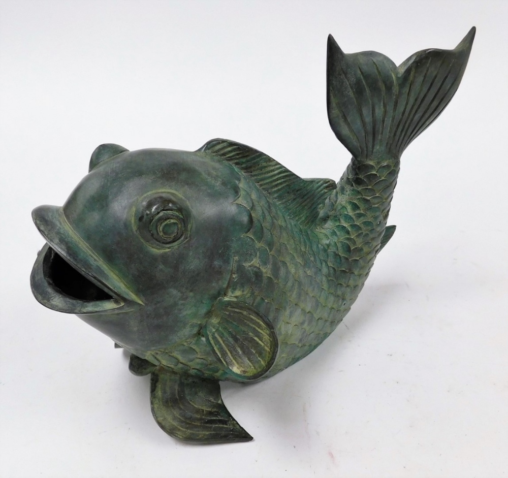 A heavy bronze patinated stylized carp, with upturned tail, 25cm high, 35cm long.