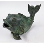 A heavy bronze patinated stylized carp, with upturned tail, 25cm high, 35cm long.