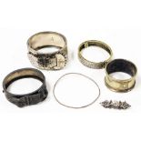 A group of silver and other bangles, to include a Victorian silver hanged bangle with buckle decorat