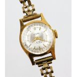 A ladies Velma 9ct gold cased wrist watch, with small circular silver coloured dial on a 9ct gold st