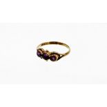 A 9ct gold amethyst dress ring, with three amethysts in rub over setting with pierced and open work
