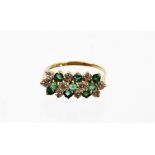 A 9ct gold dress ring, with three layered design set with emeralds and cz stones, each in clawed set
