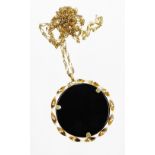 A 9ct gold pendant and chain, the circular pendant set with black agate stone, in a 9ct gold twist s