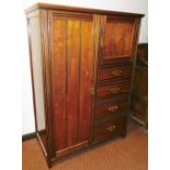 A late Victorian walnut and ebonised small wardrobe/compactum, with single panel door above box door