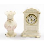 Two items of Belleek, to include a vine clock, 20cm high, and a pink floral flared vase, 16cm high.
