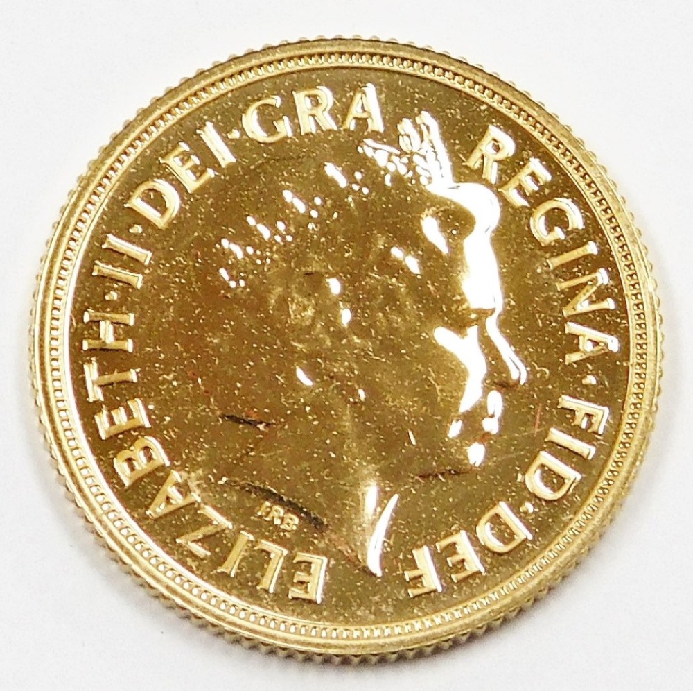 An Elizabeth II full gold sovereign, dated 2014, in plastic coin casing. - Image 2 of 2