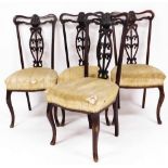 A set of four Edwardian mahogany dining chairs, each with cream upholstered and striped seats, 93cm