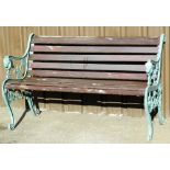 A cast iron and wooden slatted bench, the lion scroll supports painted green on wooden slats, 80cm h