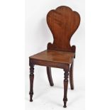 A late 19thC oak hall chair, with shield back on turned front legs and splayed back legs, of plain d