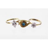 Three various dress rings, to include two single stone diamond simulates, each gold coloured but sta