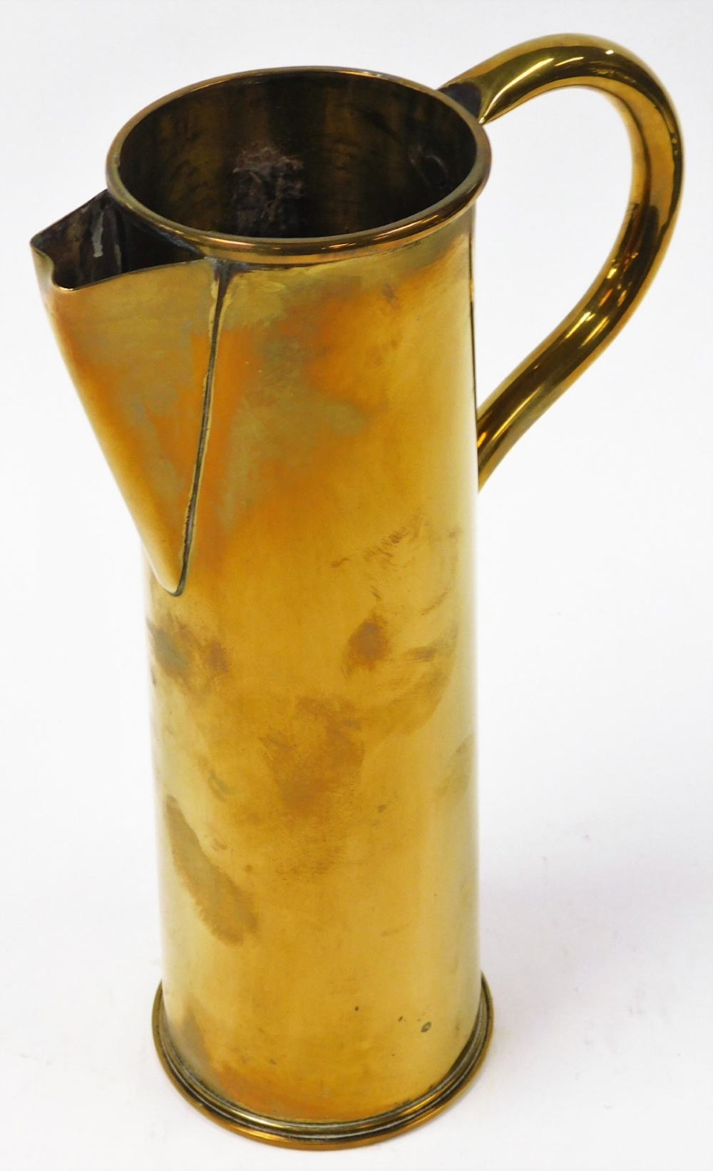 A brass shell case converted to a jug, the shell case stamped 4/16 EWBC, with conversion with spout