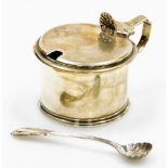 A George V silver mustard, with shell cap lid, lacking liner and with later silver plated spoon the