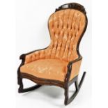 A 19thC mahogany show frame swing back rocking chair, a pink floral upholstered button back, on rock