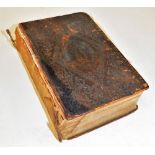 A 19thC leather bound Holy Bible, with inscription dated 1835, with a Christian motto crest to exter