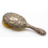 A George V silver backed dressing table brush, with Medusa figures and bearing the initials NI, Lond