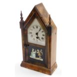 An American Gothic style mantel clock, with an arched top above silvered dial with painted rectangul