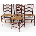 A set of four oak Arts & Crafts rush seated chairs, each with three splayed carved panel back on rus