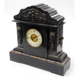 A late 19thC black slate mantel clock, with cherub urn and Medusa carved panels, with a cream dial,