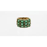 A 9ct gold emerald and diamond dress ring, with four rows of oval cut emeralds, with illusion set ti