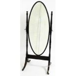 A 19thC mahogany cheval mirror, the oval cheval mirror plate on four splayed leg stand with brass ca