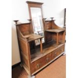 A late 19thC Arts & Crafts oak dressing table, the rectangular central mirror section with two panel