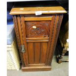 An oak pot cupboard, with carved panel door.