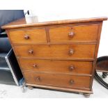 A Victorian mahogany chest, of two short and three long drawers, each with knob handles, on bun feet