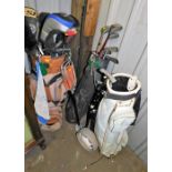 Various golf clubs and caddy bags, together with a shooting stick.